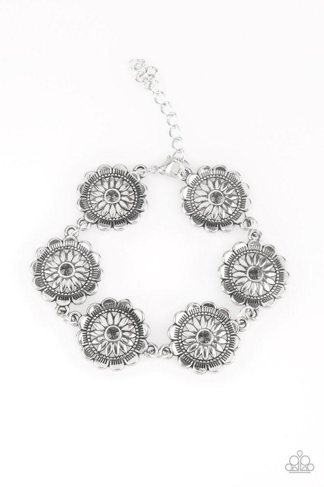 Paparazzi Accessories Funky Flower Child - Silver Dotted with smoky rhinestone centers, ornate silver floral frames link across the wrist for a seasonal look. Features an adjustable clasp closure. Sold as one individual bracelet. Jewelry
