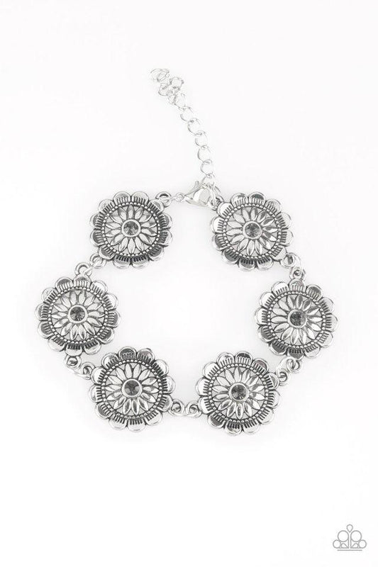 Paparazzi Accessories Funky Flower Child - Silver Dotted with smoky rhinestone centers, ornate silver floral frames link across the wrist for a seasonal look. Features an adjustable clasp closure. Sold as one individual bracelet. Jewelry