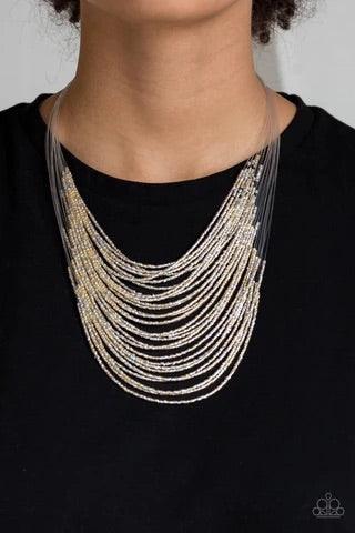 Paparazzi Accessories Catwalk Queen - Multi Strand after strand of metallic gold and silver seed beads fall together to create a bold statement piece. Features an adjustable clasp closure. Sold as one individual necklace. Includes one pair of matching ear