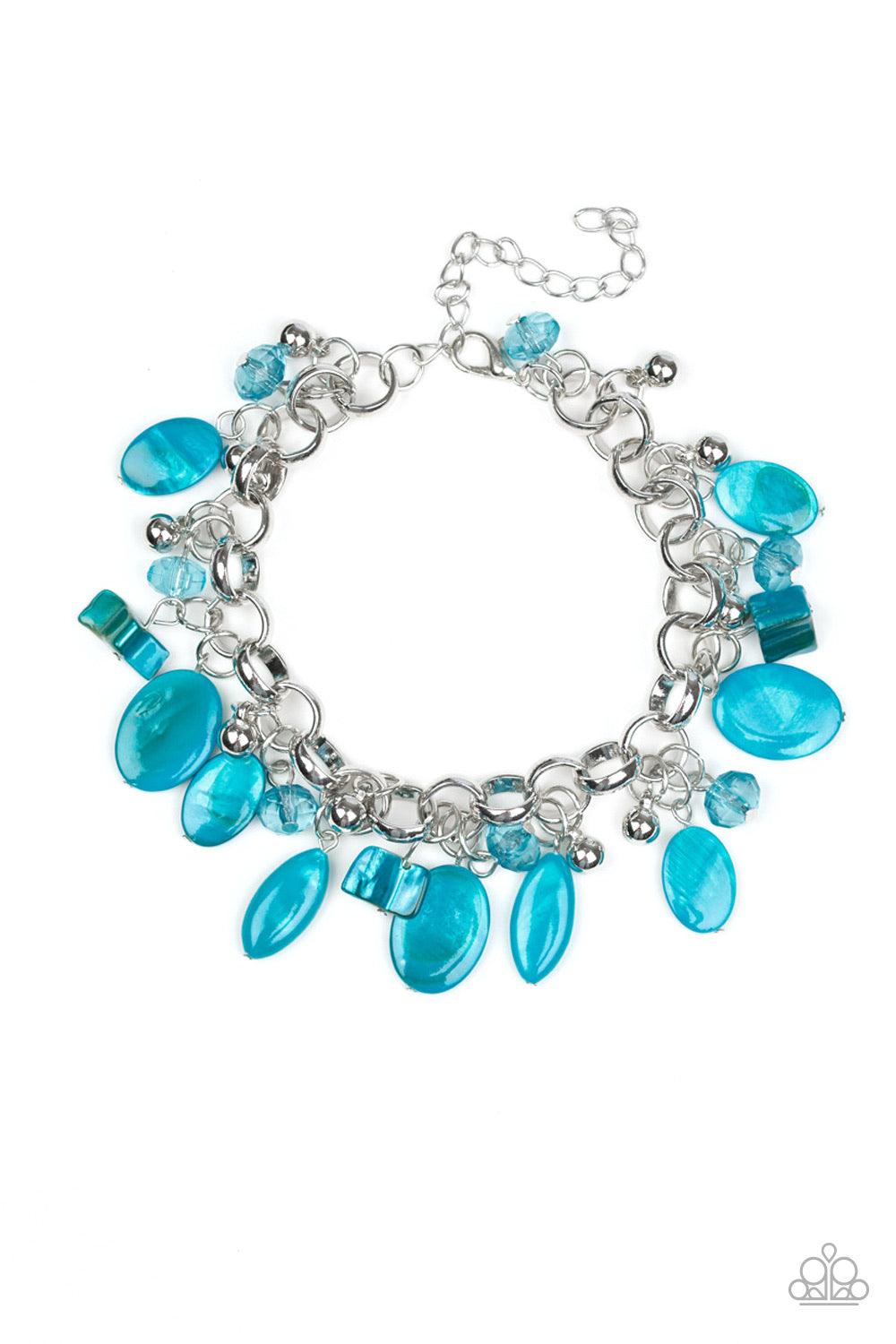 Paparazzi Accessories Seashore Sailing - Bracelet A collection of blue shell-like beads, blue crystal-like beads, and shiny silver beads swing from a bold silver chain, creating a whimsical fringe around the wrist. Features an adjustable clasp closure. Je