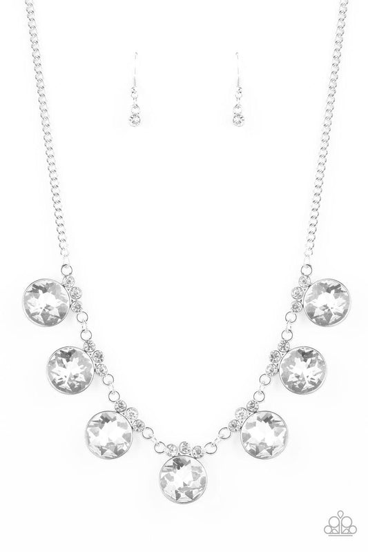 Paparazzi Accessories GLOW-Getter Glamour - White Crowned in a trio of dainty white rhinestones, an exaggerated display of oversized white gems delicately links below the collar for a glamorous glow. Features an adjustable clasp closure. Jewelry