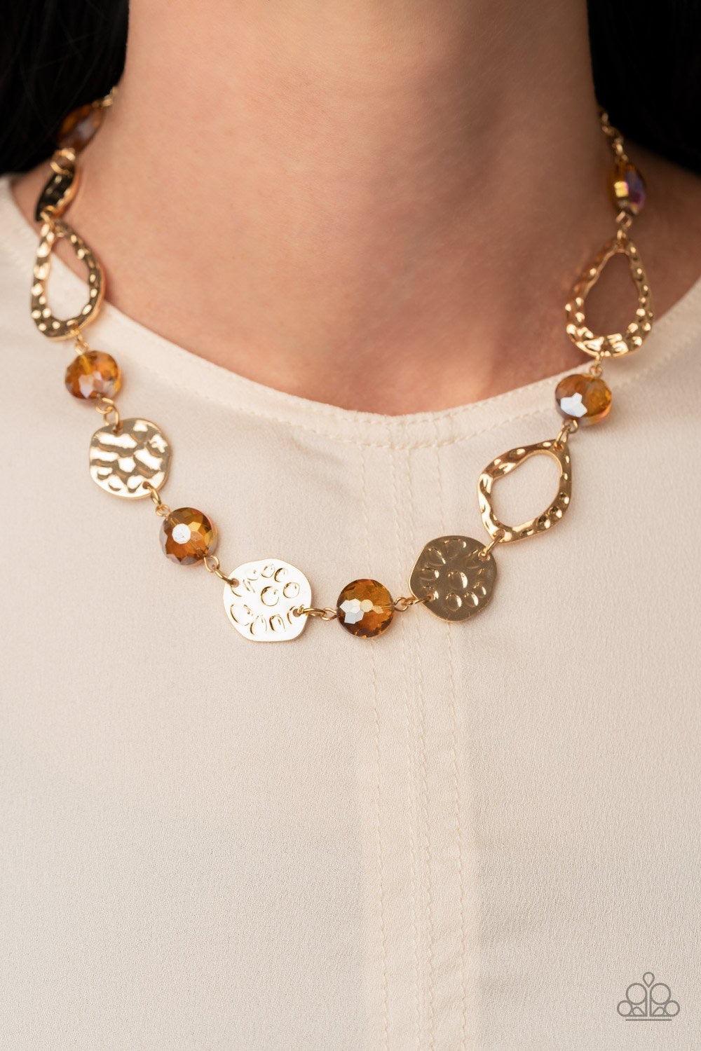Paparazzi Accessories High Fashion Fashionista - Brown Hammered gold frames and imperfect gold ovals link with iridescent topaz gems below the collar, creating a colorful display. Features an adjustable clasp closure. Sold as one individual necklace. Incl