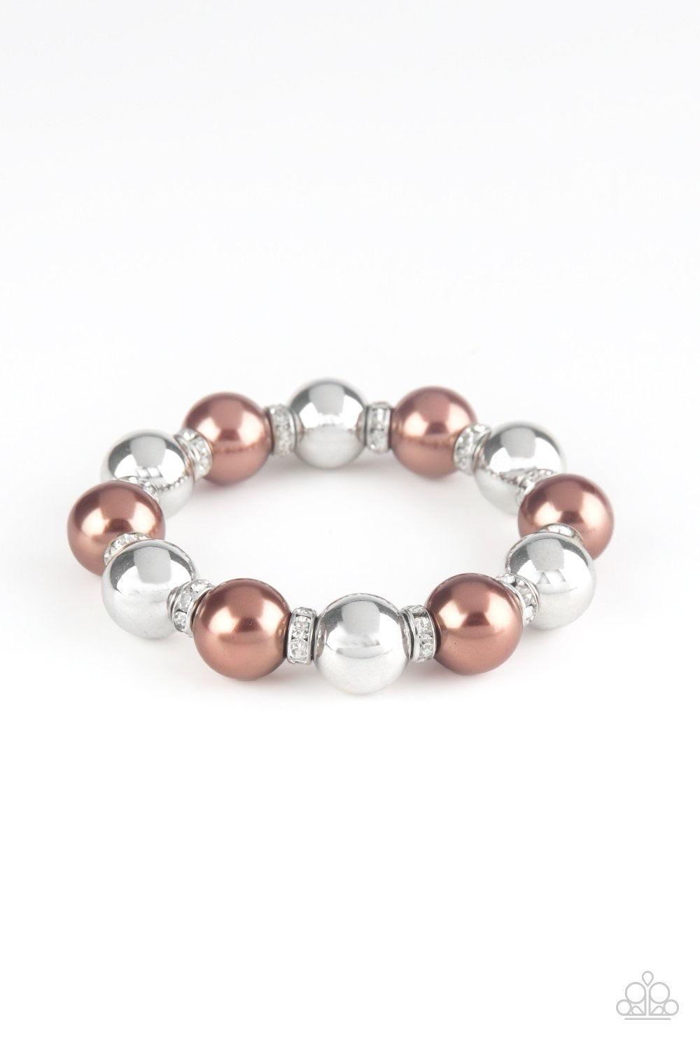 Paparazzi Accessories So Not Sorry - Brown A collection of white rhinestone encrusted rings, brown pearls, and classic silver beads are threaded along a stretchy band around the wrist for a glamorous look. Jewelry