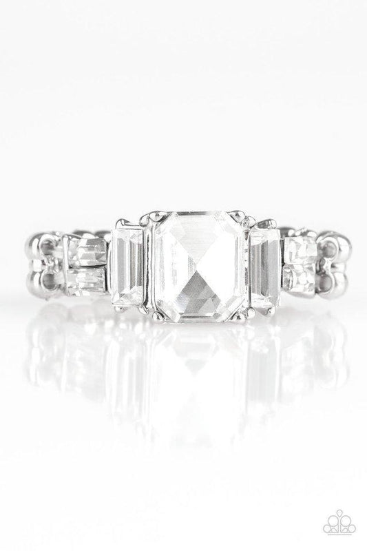 Paparazzi Accessories Born to Rule - White Varying in cut and shimmer, glittery white rhinestones stack into a glamorous band across the finger. Features a dainty stretchy band for a flexible fit.Sold as one individual ring. Jewelry