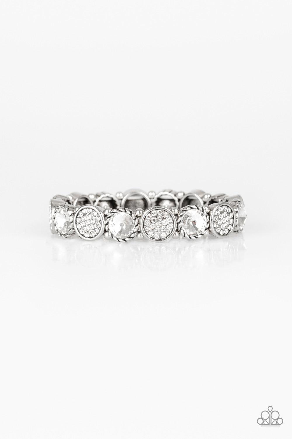 Paparazzi Accessories Take A Moment To Reflect - White Featuring an array of glittery white rhinestones, mismatched silver frames and dainty silver beads are threaded along stretchy bands around the wrist for a glamorous flair. Jewelry