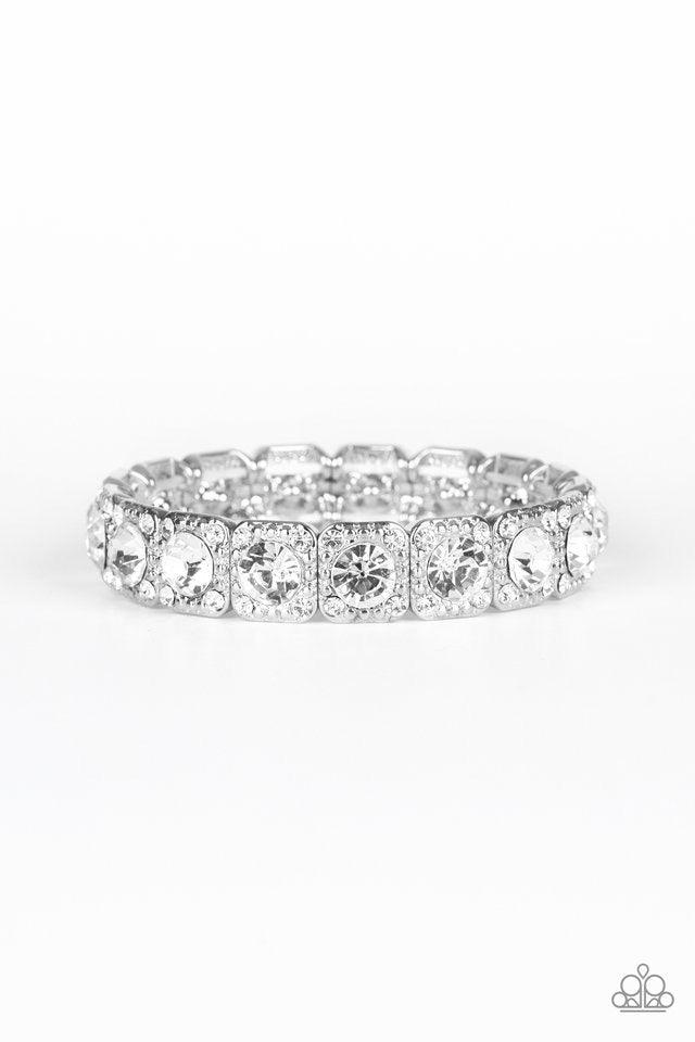 Paparazzi Accessories Blinged Out - White Featuring oversized white rhinestone centers, studded silver frames radiating in glassy white rhinestones are threaded along a stretchy band around the wrist for a glamorous fashion. Jewelry
