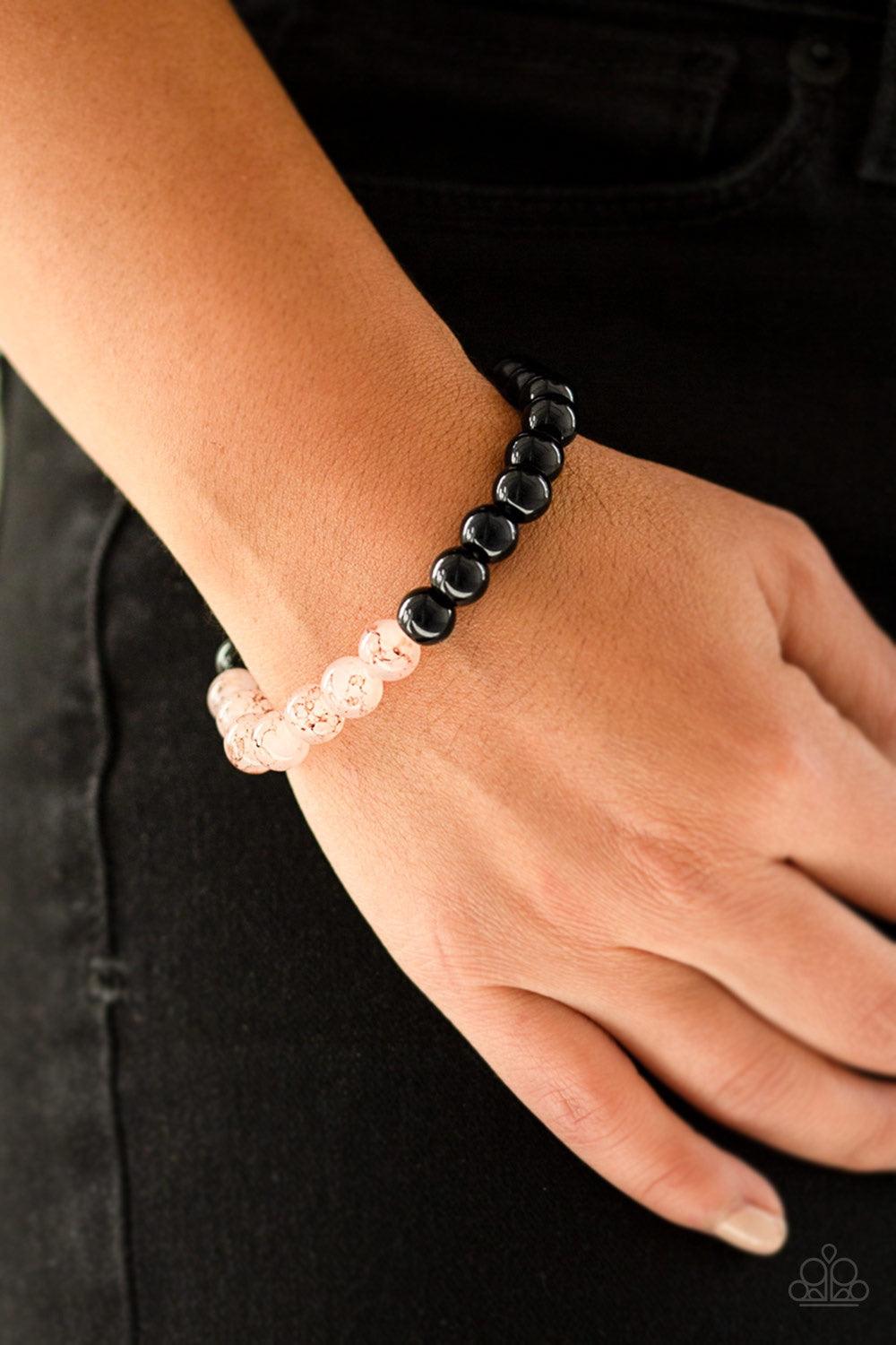 Paparazzi Accessories Cool And Content - Pink Glassy pink and polished black beads are threaded along a stretchy band for a seasonal look. Jewelry