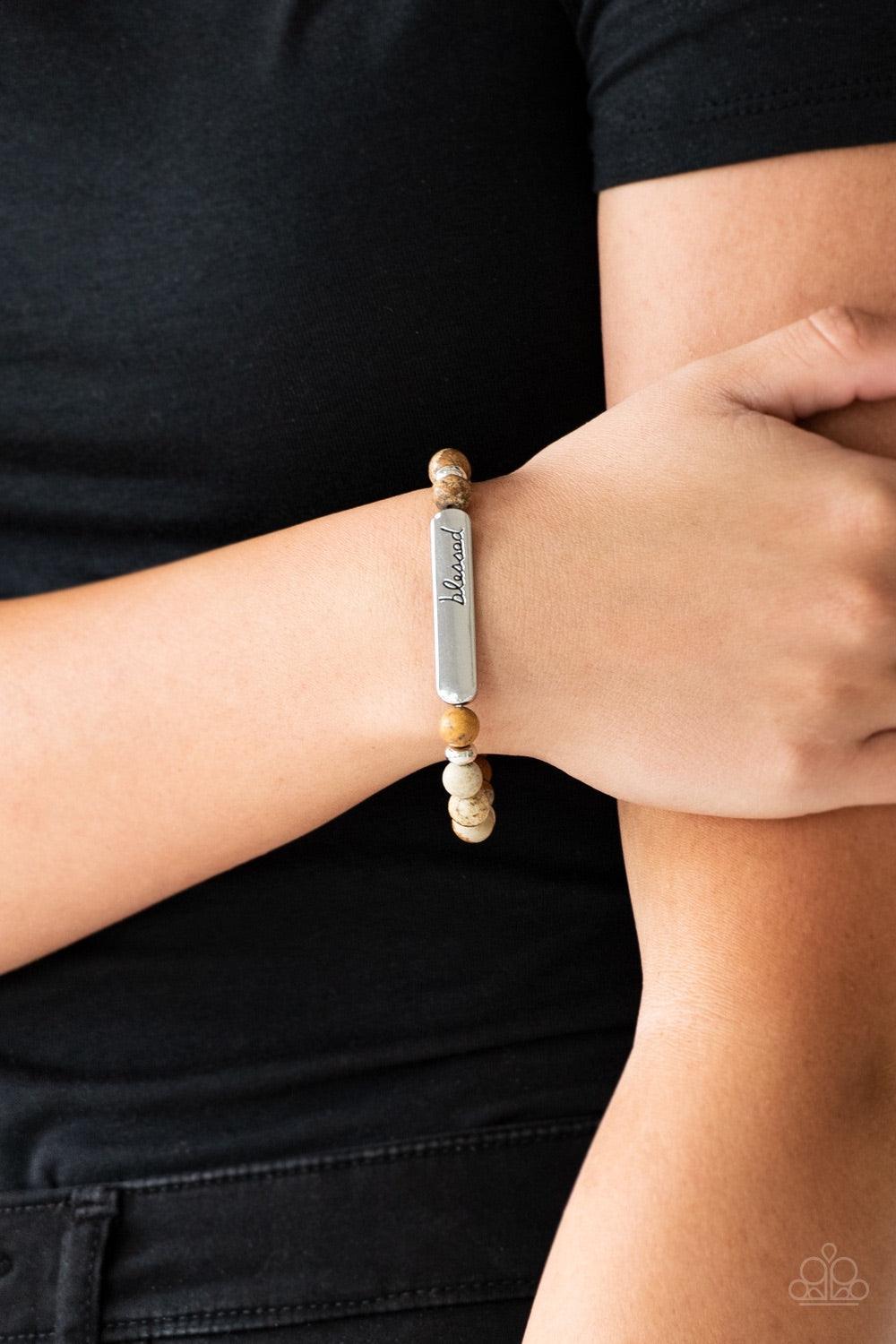 Paparazzi Accessories Born Blessed - Brown Infused with dainty silver accents, a collection of colorful natural stones are threaded along a stretchy band. A glistening silver frame engraved with the word, "blessed" adorns the center for a seasonal finish.