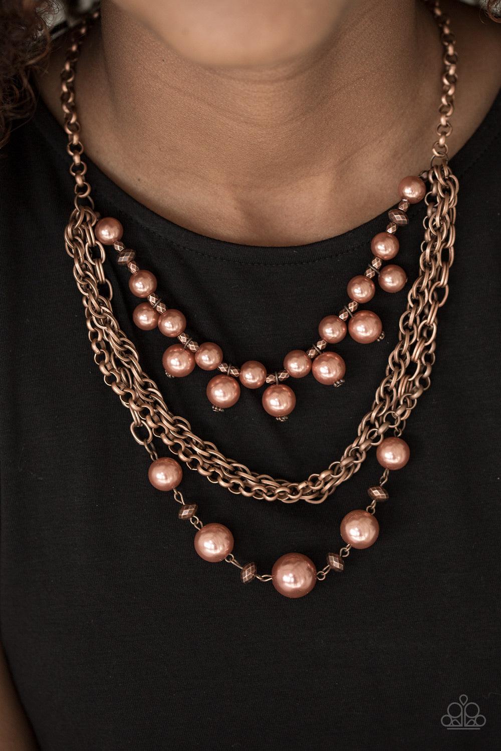 Paparazzi Accessories Urban Riches ~Copper Varying in shape and shimmer, glistening copper chains layer below the collar in a bold industrial fashion. Brushed in a pearly metallic finish, shimmery copper beads and faceted beading trickle along two chains,