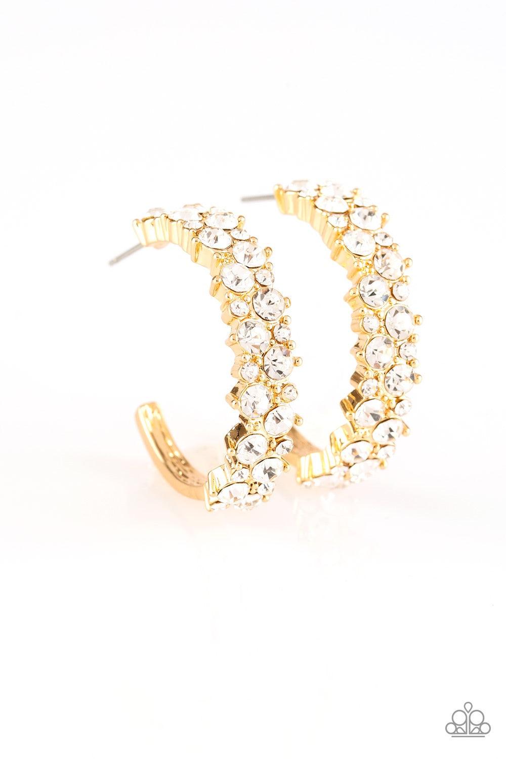 Paparazzi Accessories Glitter Galaxy - Gold Encrusted in glassy white rhinestones, a thick gold hoop curls around the ear for a glamorous look. Earring attaches to a standard post fitting. Hoop measures 1" in diameter. Jewelry