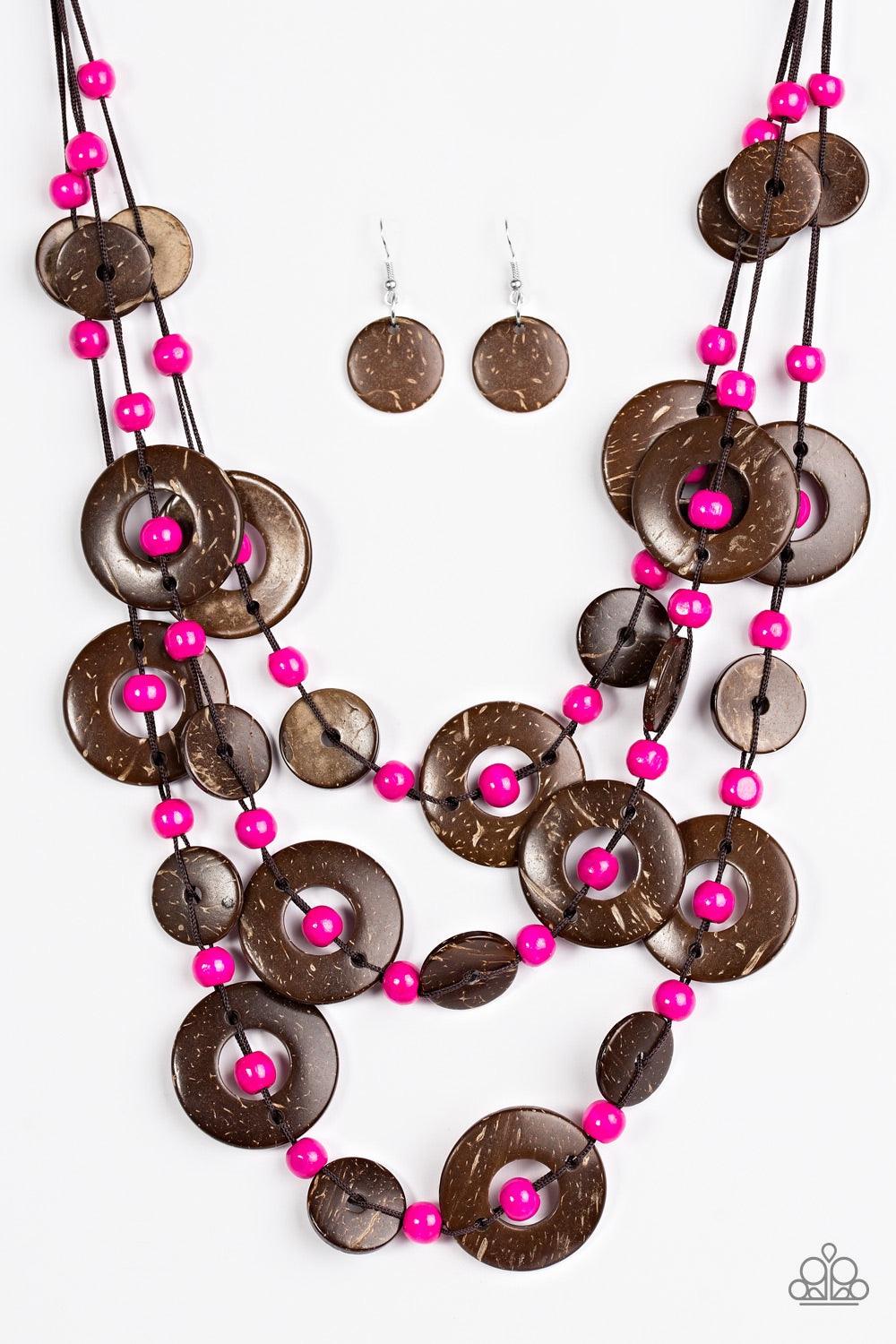 Paparazzi Accessories Bahama Bungalow - Pink Brushed in a distressed finish, wooden discs link into three summery rows below the collar. Round pink beads are knotted between the wooden accents, adding colorful accents to the seasonal palette. Features a b