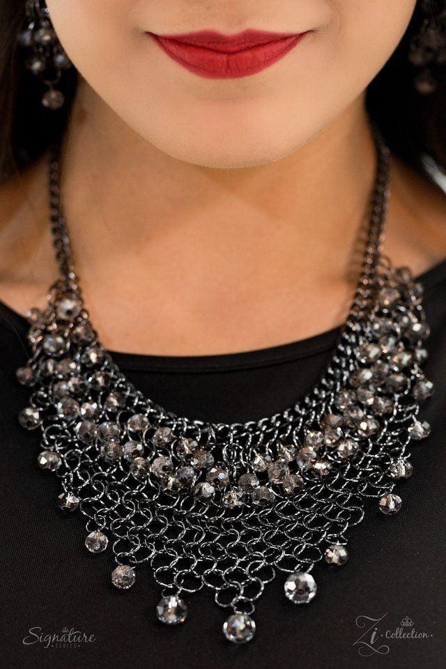 Paparazzi Accessories The Nina Interlocking gunmetal links join into a tapered mesh down the chest. Featuring a sparkling faceted surface, glittery crystal-like beading swings from the top and bottom of the fierce palette for a hypnotizing finish. Feature