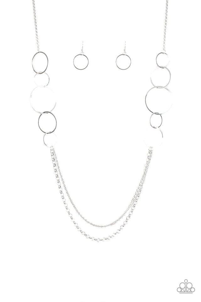 Paparazzi Accessories Ring In The Radiance - Silver A collection of interlocking silver rings give way to layers of mismatched silver chains down the chest, creating a stunning tone-on-tone statement piece. Features an adjustable clasp closure. Sold as on