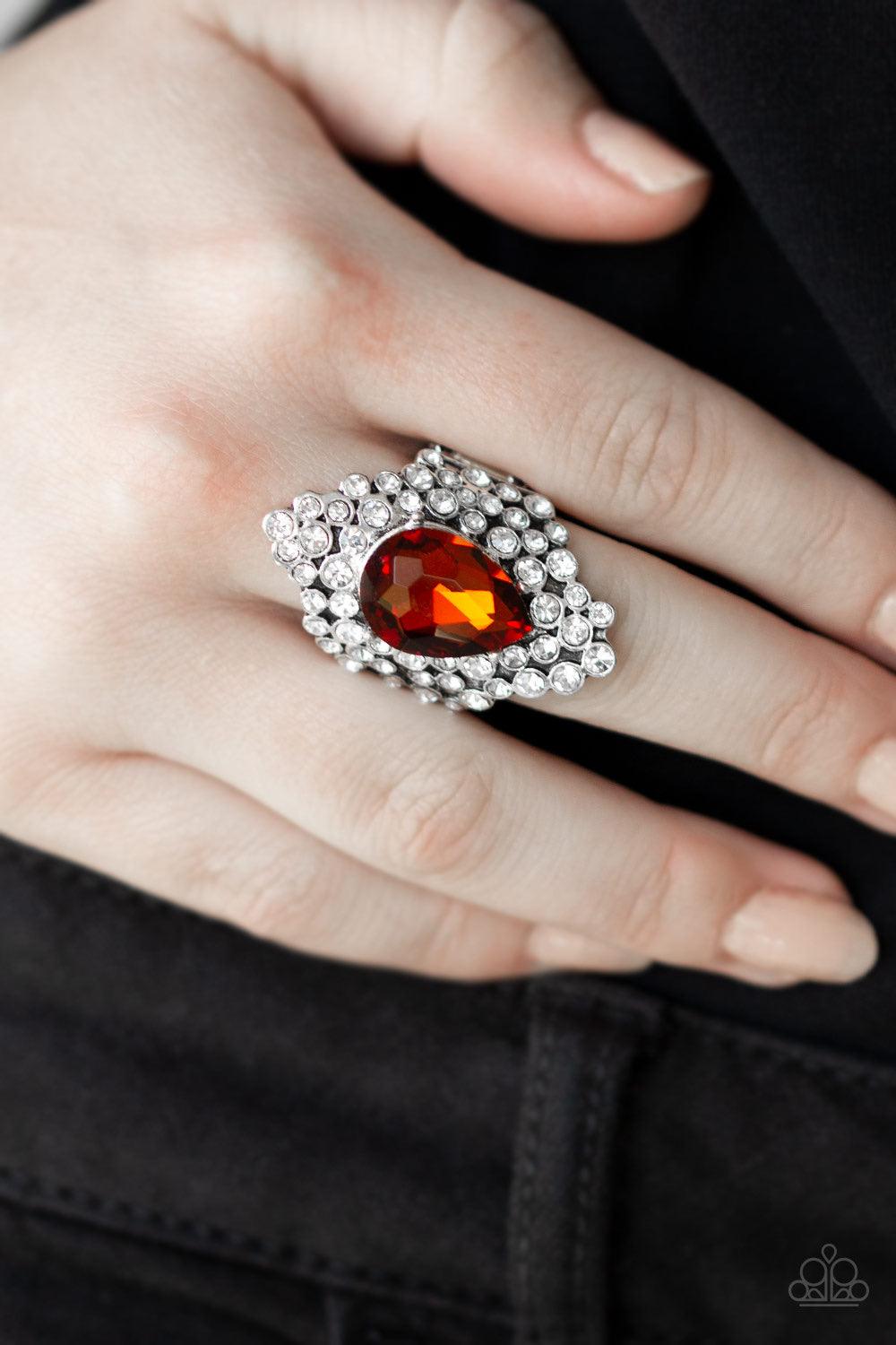 Paparazzi Accessories Hollywood Heiress - Brown Featuring a regal teardrop cut, a glittery gem is pressed into the center of a sparkling backdrop of glassy white rhinestones, creating a blinding centerpiece atop the finger. Features a stretchy band for a