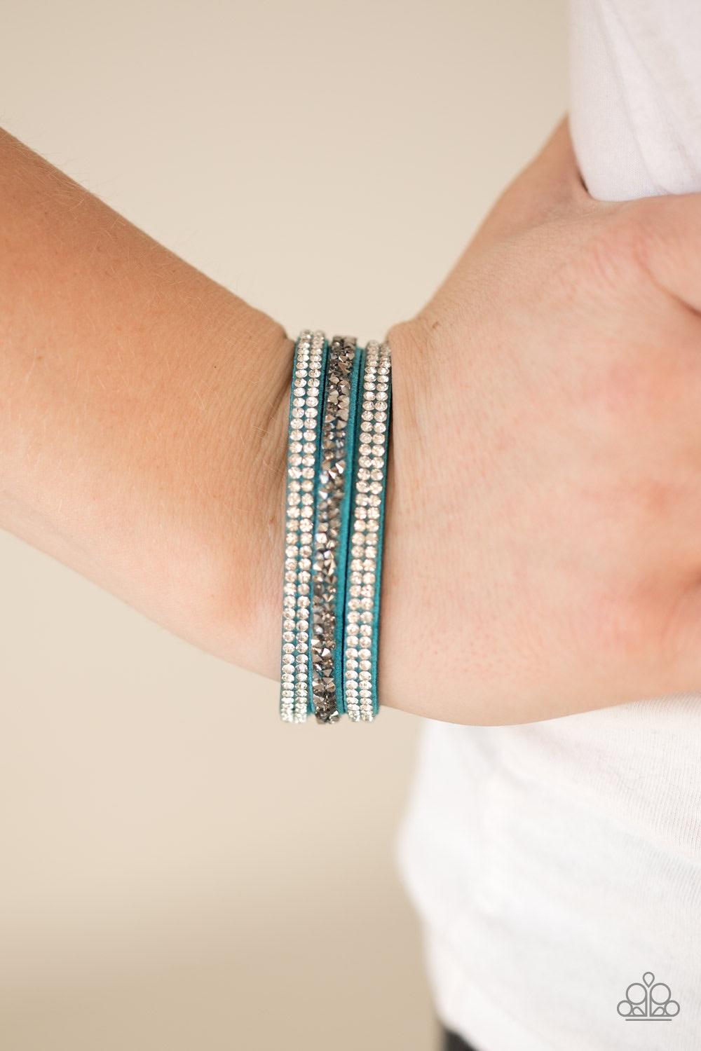 Paparazzi Accessories Mega Glam - Blue Glittery white, smoky, and glassy hematite rhinestones are sprinkled along three strands of refreshing blue suede for a glamorous look. Features an adjustable snap closure. Jewelry