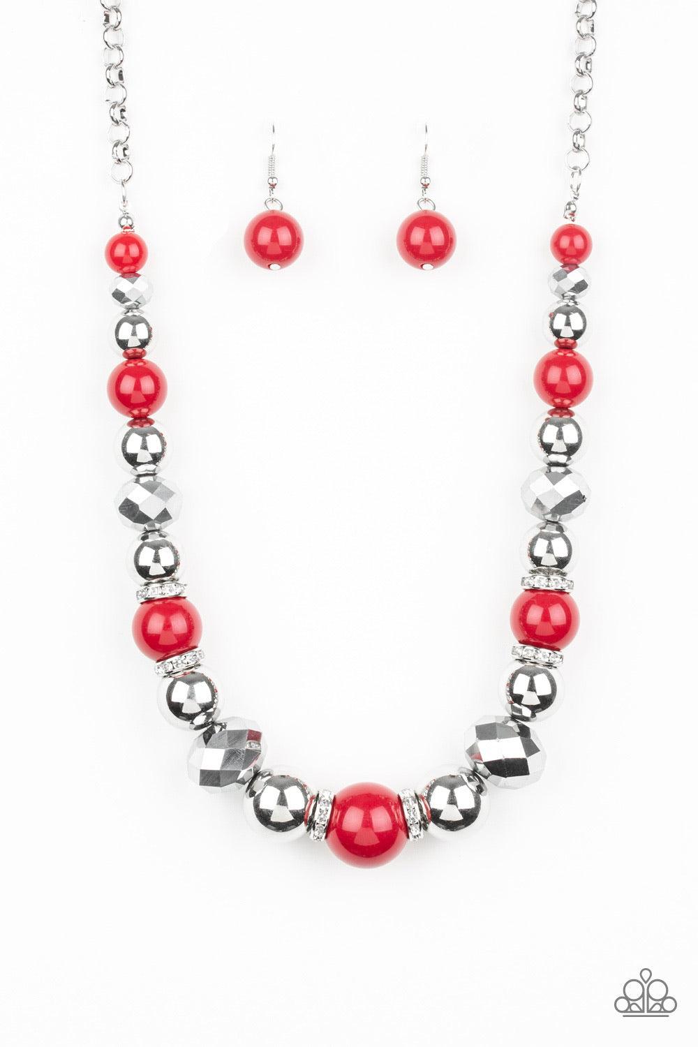 Paparazzi Accessories Weekend Party ~Red A collection of oversized silver beads, robust Samba beads, white rhinestone encrusted rings, and metallic crystal-like beads are threaded along an invisible wire below the collar for a glamorous statement-making f
