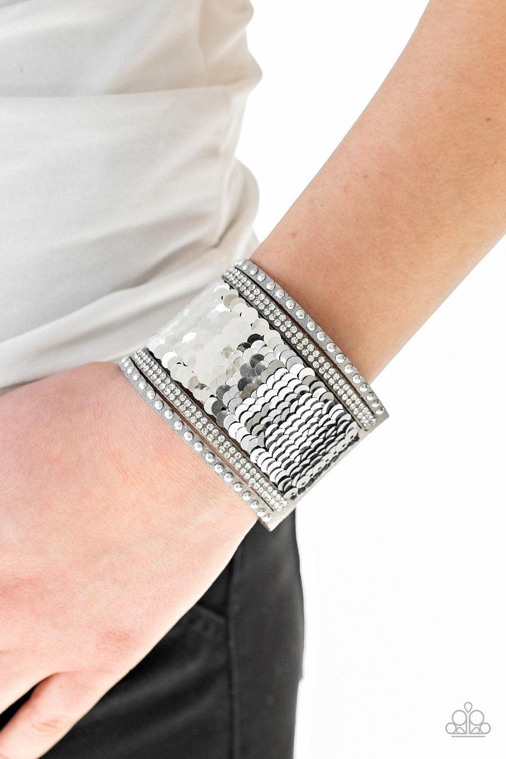 Paparazzi Accessories MERMAIDS Have More Fun - Silver Shiny silver studs, glassy white rhinestones, and shimmering sequins are sprinkled across a thick gray suede band that has been spliced into five glittery rows. Bracelet features reversible sequins tha