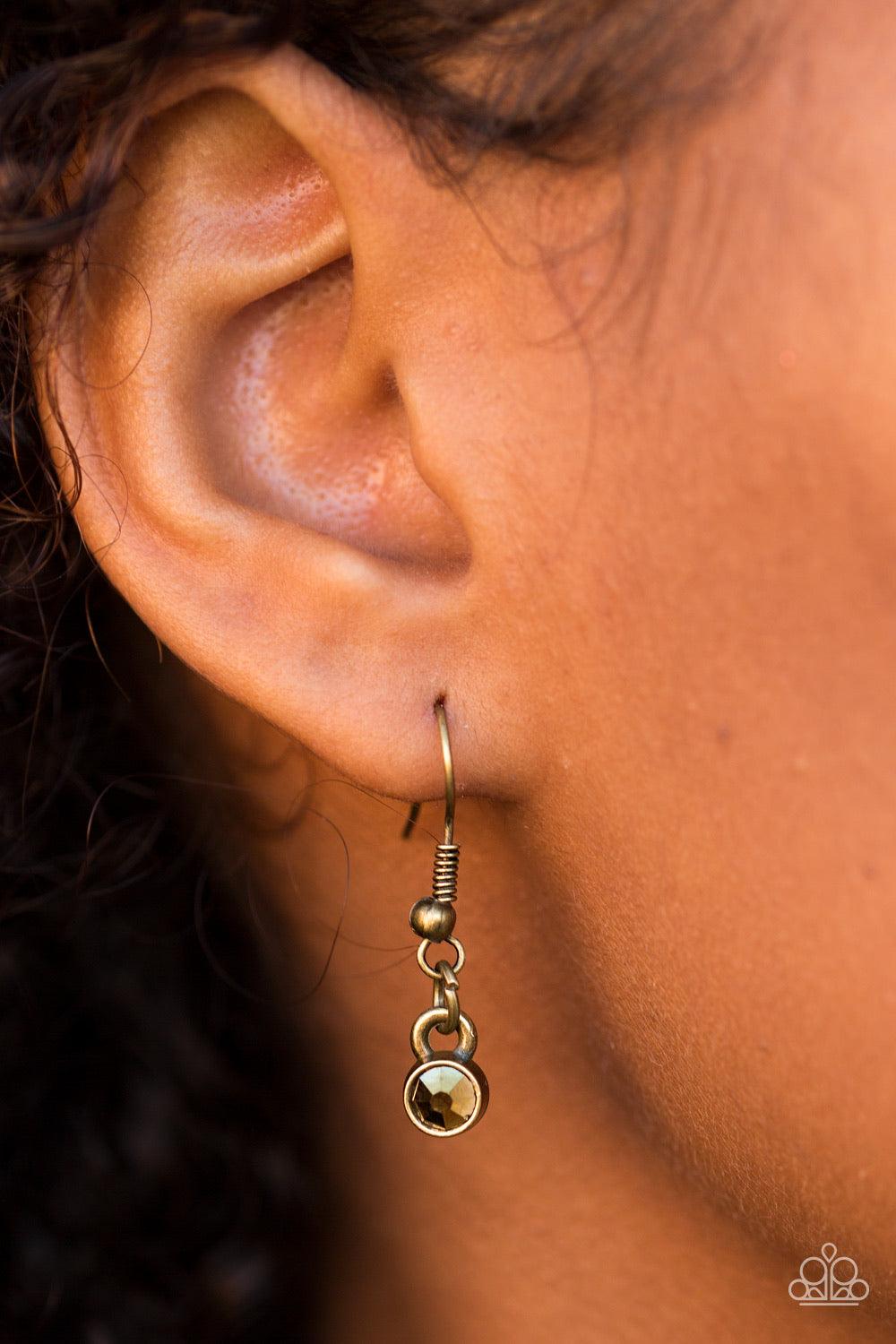 Paparazzi Accessories Over The Edge - Brass Encrusted in glittery aurum rhinestones, dainty diamond-shaped frames give way to matching brass frames, creating an edgy fringe below the collar. Features an adjustable clasp closure. Sold as one individual nec
