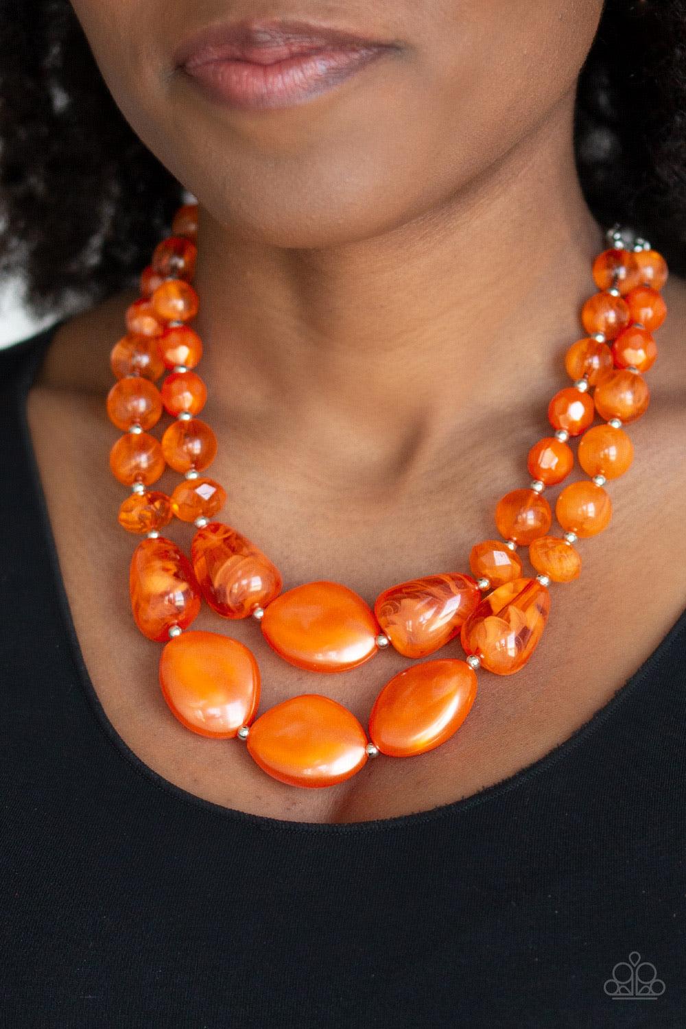 Paparazzi Accessories Beach Glam - Orange Varying in shape and opacity, a refreshing collection of glassy and iridescent Amberglow beads layer below the collar for a boldly colorful look. Features an adjustable clasp closure. Sold as one individual neckla