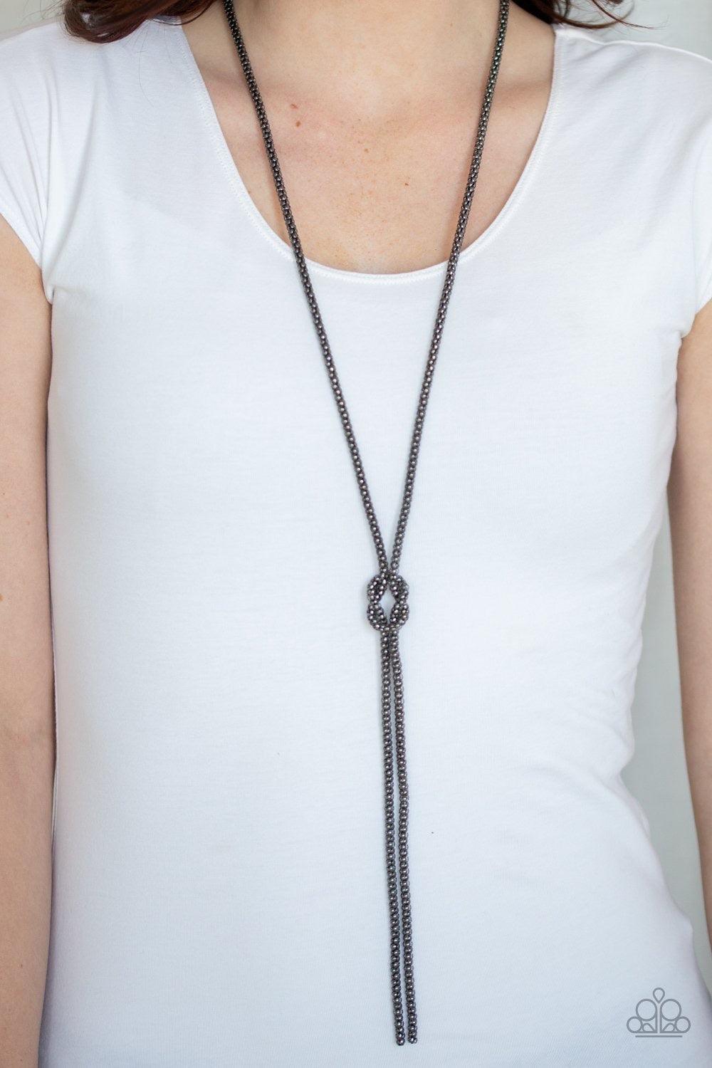 Paparazzi Accessories Born Ready - Black A glistening strand of lengthened gunmetal popcorn chain delicately knots at the chest, creating an edgy tasseled pendant. Features an adjustable clasp closure. Sold as one individual necklace. Includes one pair of