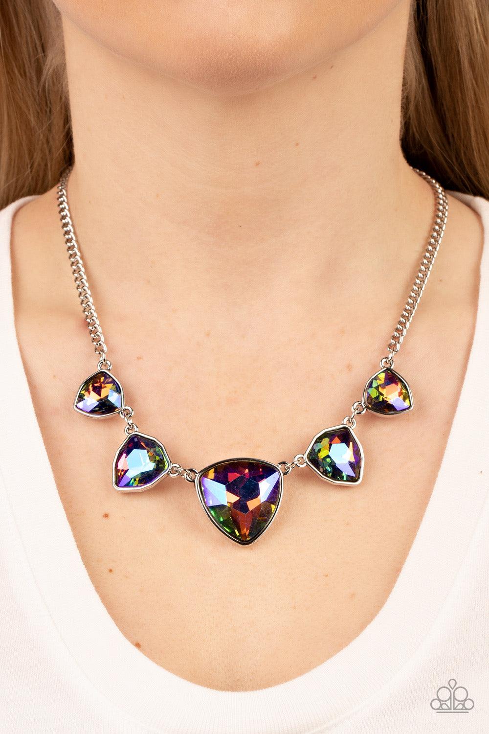 Paparazzi Accessories Cosmic Constellations - Multi Encased in sleek silver fittings, an oversized collection of UV geometric gems gradually increase in size as they link below the collar for a stellar statement. Features an adjustable clasp closure. Due