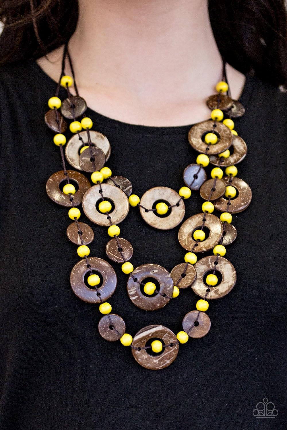 Paparazzi Accessories Bahama Bungalow - Yellow Brushed in a distressed finish, wooden discs link into three summery rows below the collar. Round yellow beads are knotted between the wooden accents, adding colorful accents to the seasonal palette. Features
