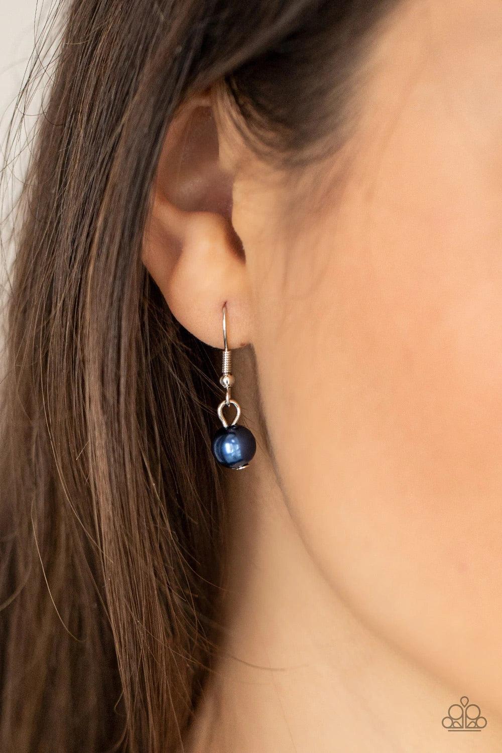 Paparazzi Accessories Remarkable Radiance - Blue A dramatically oversized blue pearl gives way to two mismatched strands of classic blue pearls that graduate in size and imperfect finishes, adding a timeless twist to the classic pearl palette. Features an