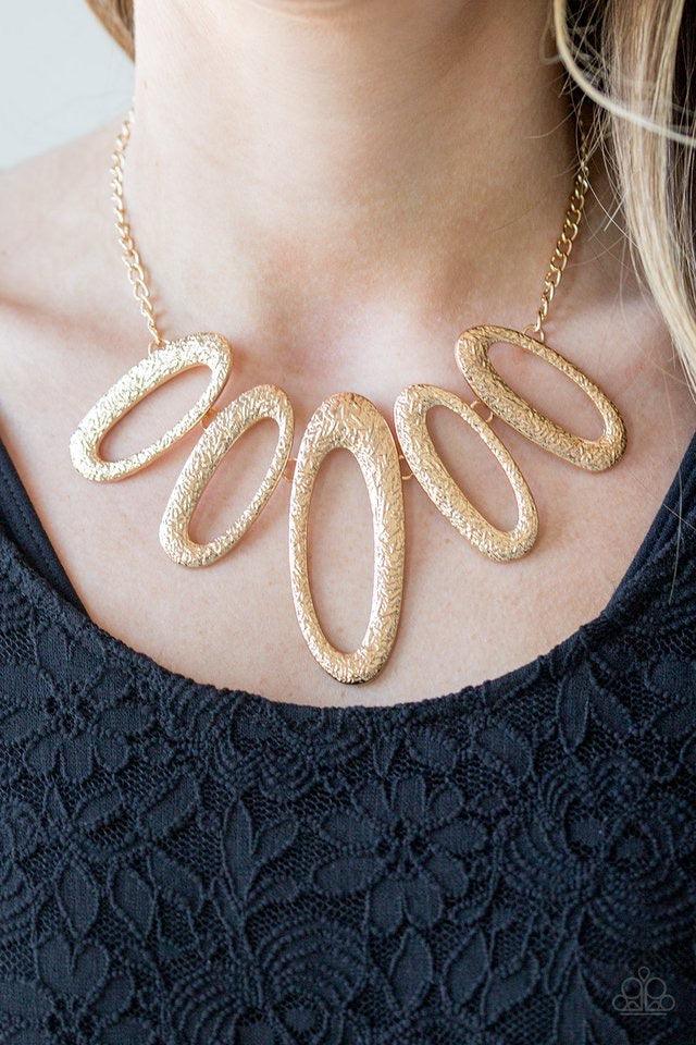 Paparazzi Accessories Easy, TIGRESS! - Gold Embossed in radiating textures, asymmetrical gold ovals link below the collar in a fierce fashion. Features an adjustable clasp closure. Sold as one individual necklace. Includes one pair of matching earrings. J
