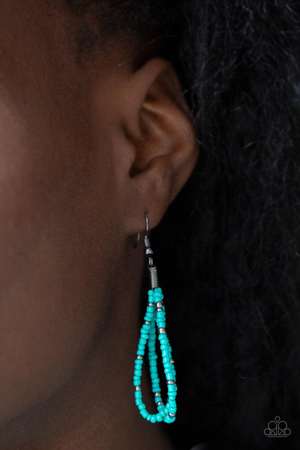 Paparazzi Accessories Rio Rainforest - Blue Suspended between two gunmetal fittings, row after row of countless strands of turquoise seed beads layer below the collar. Dainty gunmetal seed beads are sprinkled across the strands for a seasonal finish. Feat