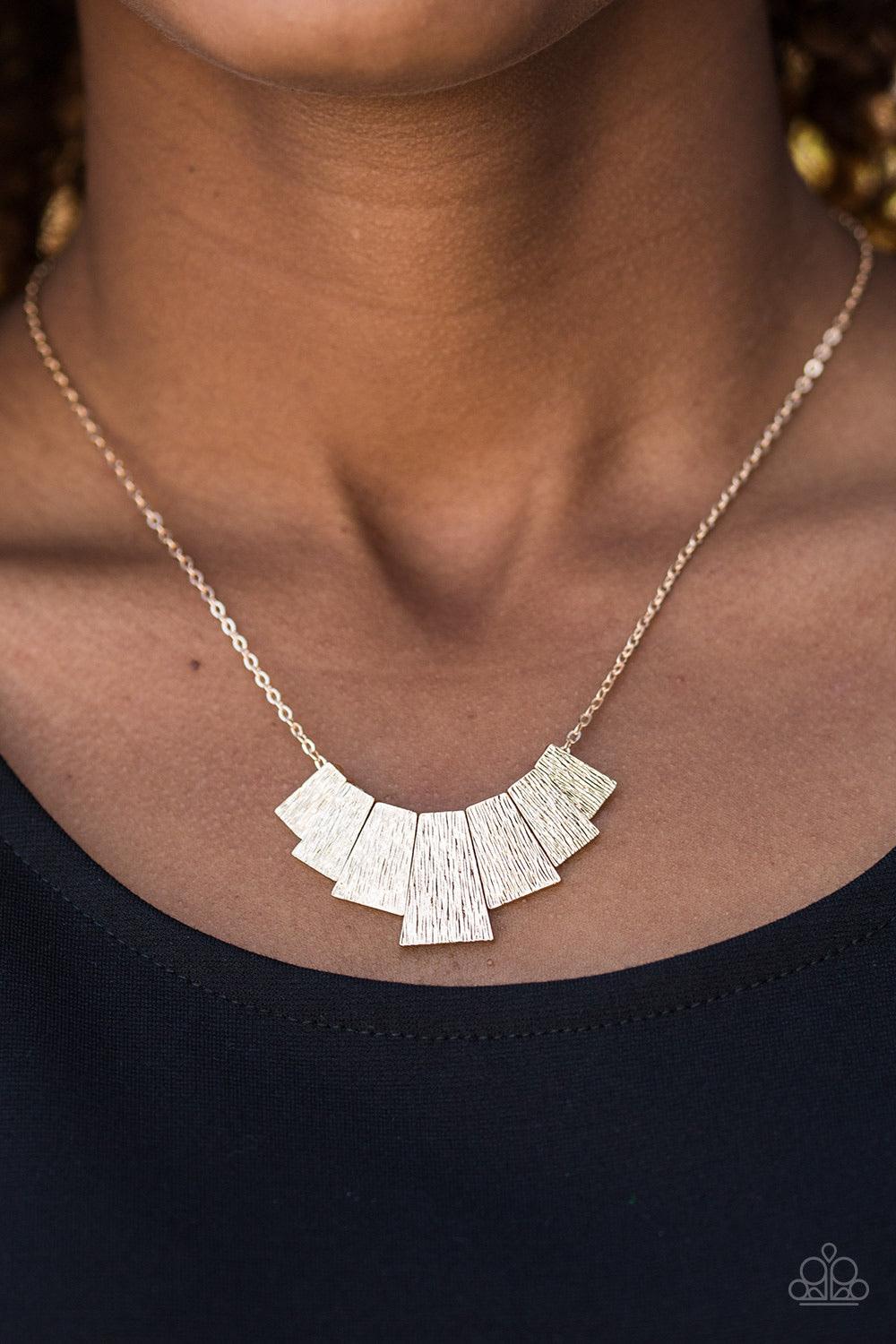 Paparazzi Accessories Cry Wolf - Gold Etched in shimmery serrated textures, flared gold plates trickle below the collar in a tribal inspired fashion. Features an adjustable clasp closure. Sold as one individual necklace. Includes one pair of matching earr