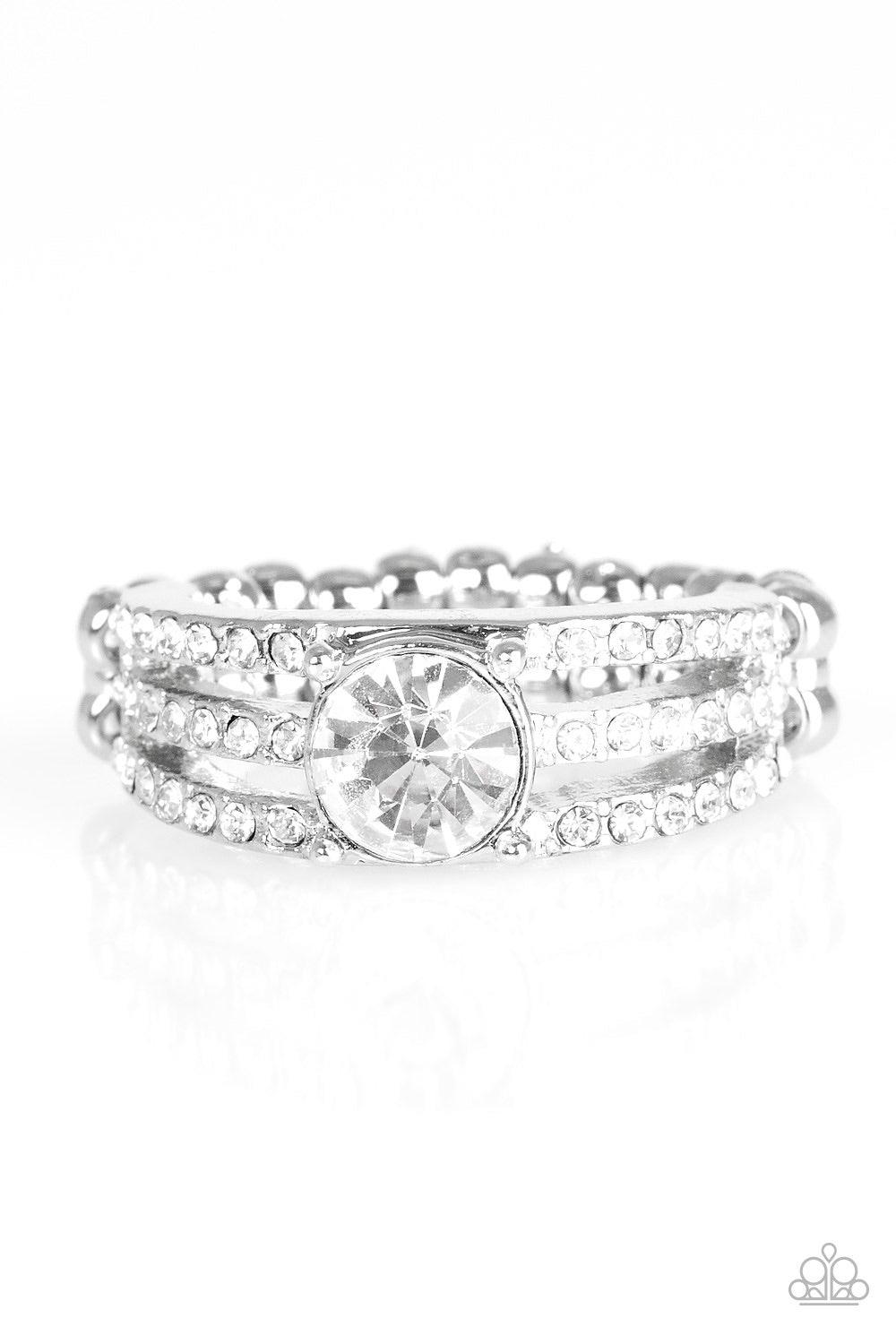 Paparazzi Accessories Champion Chic - White Encrusted in dainty white rhinestones, glistening silver bars layer across the finger, coalescing into a gorgeous band. A glittery white rhinestone is pressed into the center of the bands, creating a refined cen