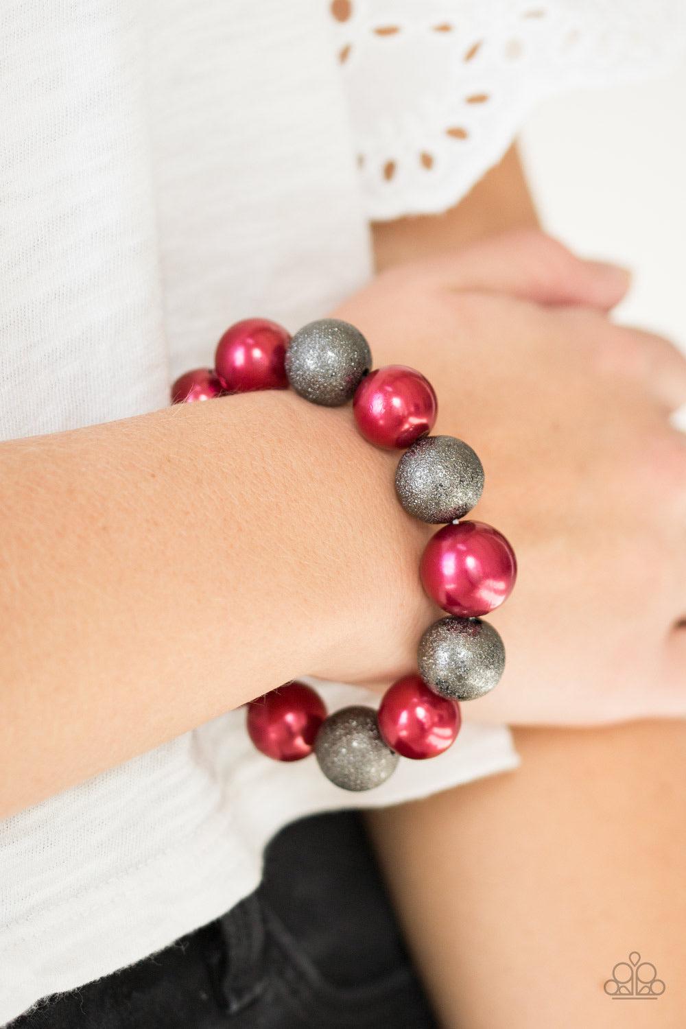 Paparazzi Accessories Humble Hustle - Red Dusted in glitter, sparkling gunmetal and pearly red beads are threaded along a stretchy band around the wrist for a glamorous look. Jewelry
