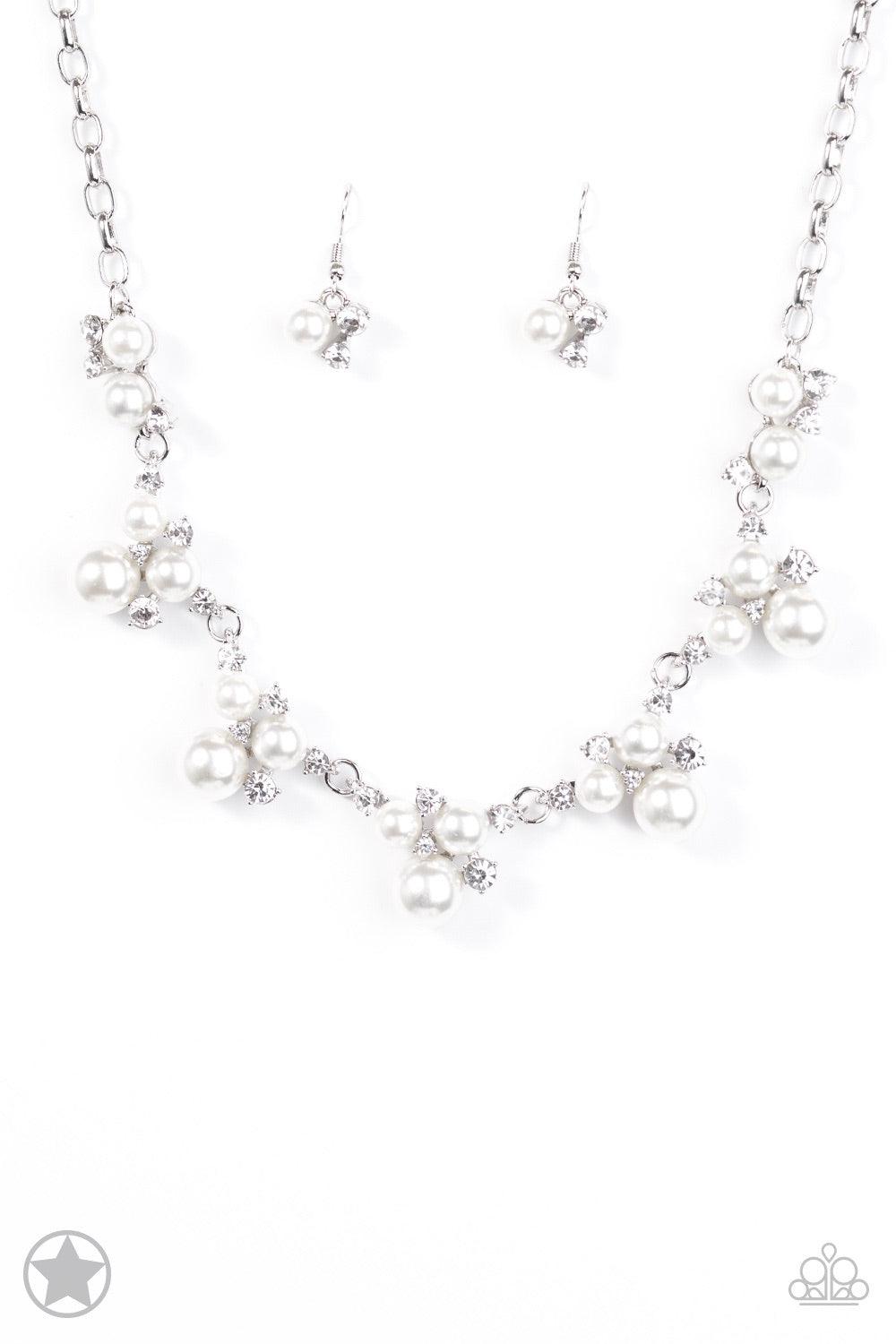 Paparazzi Accessories Toast To Perfection - White Clusters of pearls and dazzling white rhinestones join below the collar, creating refined frames. Infused with a glistening silver chain, the sections of luminescent frames trickle along the neck in a time