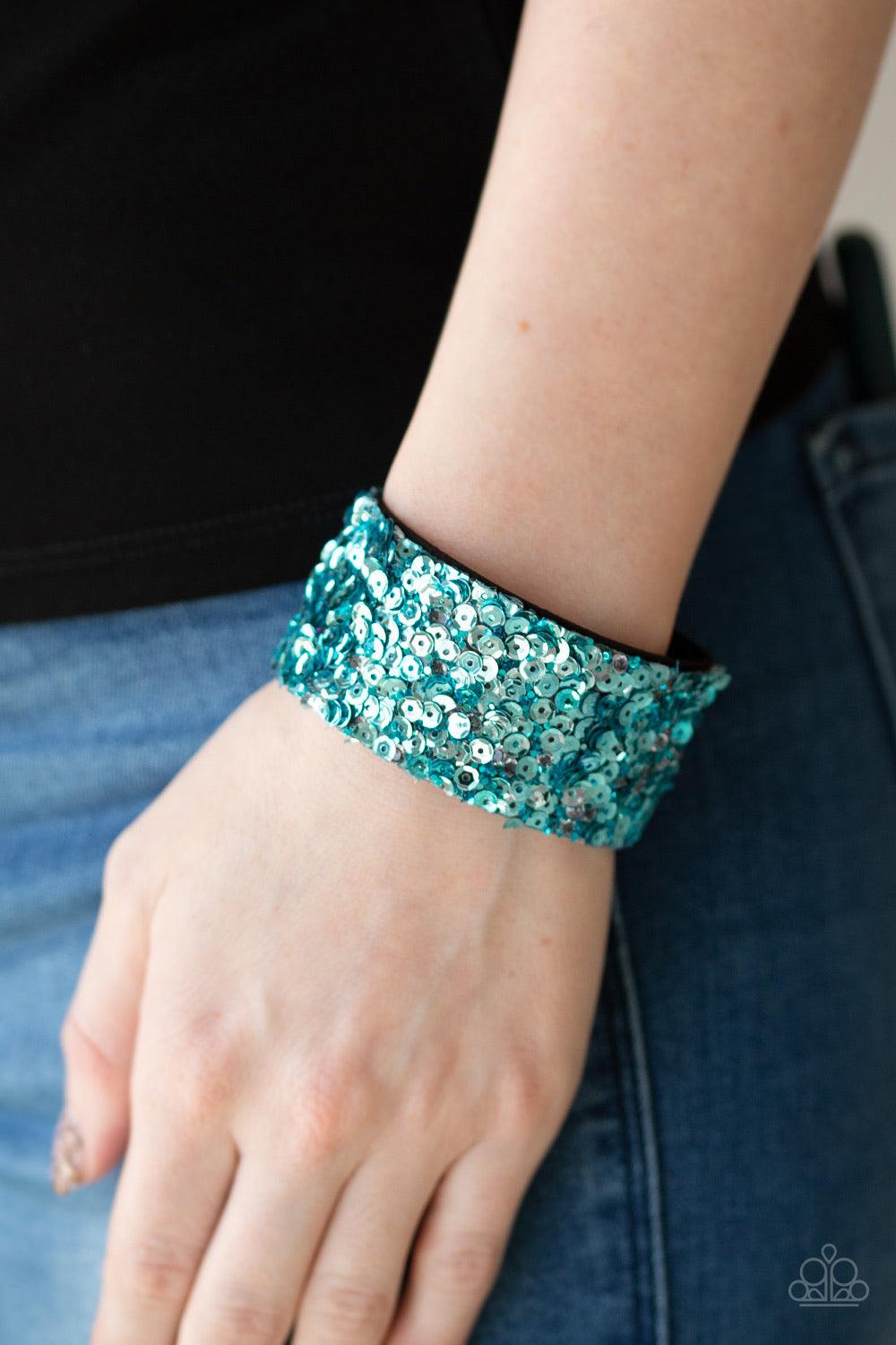 Paparazzi Accessories Starry Sequins - Blue A collision of glittery rhinestones and sparkling blue sequins are encrusted along the front of a black suede band, creating blinding shimmer around the wrist. Features an adjustable snap closure. Jewelry