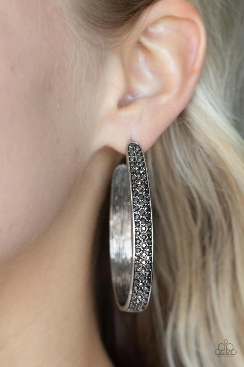 Paparazzi Accessories Bossy and Glossy - Silver Row after row of smoky hematite rhinestones are encrusted across the front of a textured silver hoop, creating a smoldering centerpiece. Earring attaches to a standard post fitting. Hoop measures approximate