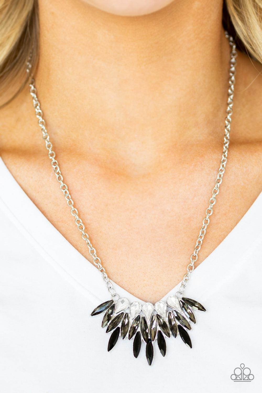 Paparazzi Accessories Crown Couture - Black Featuring regal teardrop and marquise style cuts, glittery white, smoky gray, and glassy black rhinestones fan below the collar for a dramatic look. Features an adjustable clasp closure. Sold as one individual n