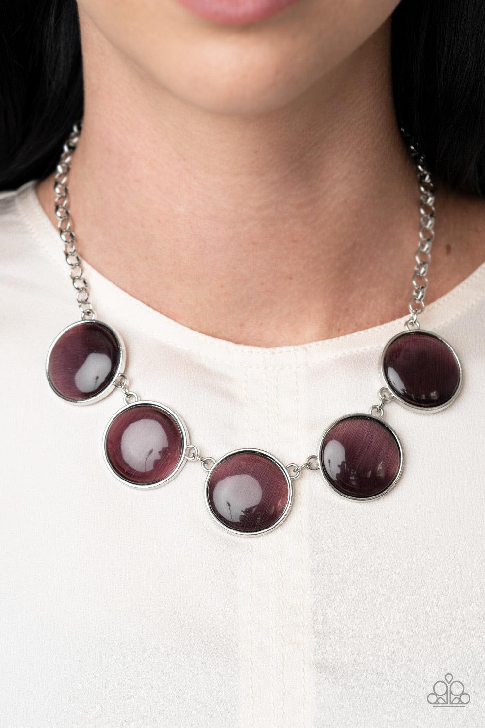 Paparazzi Accessories Ethereal Escape - Purple Featuring sleek silver fittings, a collection of round purple cat's eye stone pendants link below the collar for a colorfully ethereal look. Features an adjustable clasp closure. Sold as one individual neckla