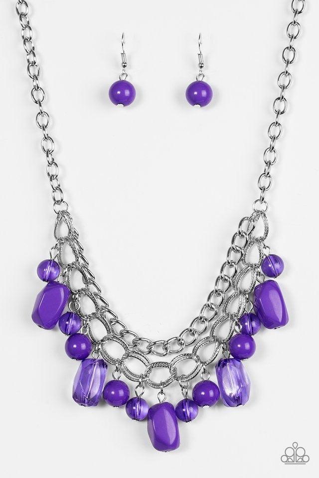 Paparazzi Accessories Brazilian Bay - Purple Featuring glassy and polished finishes, round and asymmetrical purple beads trickle from the bottom of a double-linked silver chain. An additional silver chain is layered above the summery beading for a seasona