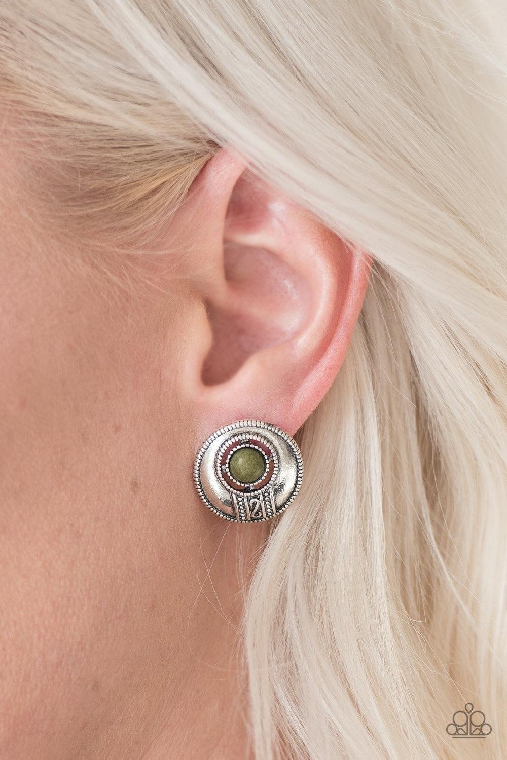 Paparazzi Accessories The Four Corners - Green A refreshing green stone adorns an antiqued suspended frame above a stunning silver filigree pattern. Silver dots dance around the outside of the stone and outer frame for an artisan inspired style. Earring a