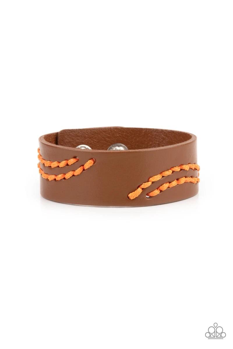 Paparazzi Accessories Harmonic Horizons - Orange Marigold cording is stitched across the front of a brown leather band, creating curved patterns. Features an adjustable snap closure. Sold as one individual bracelet. Bracelets