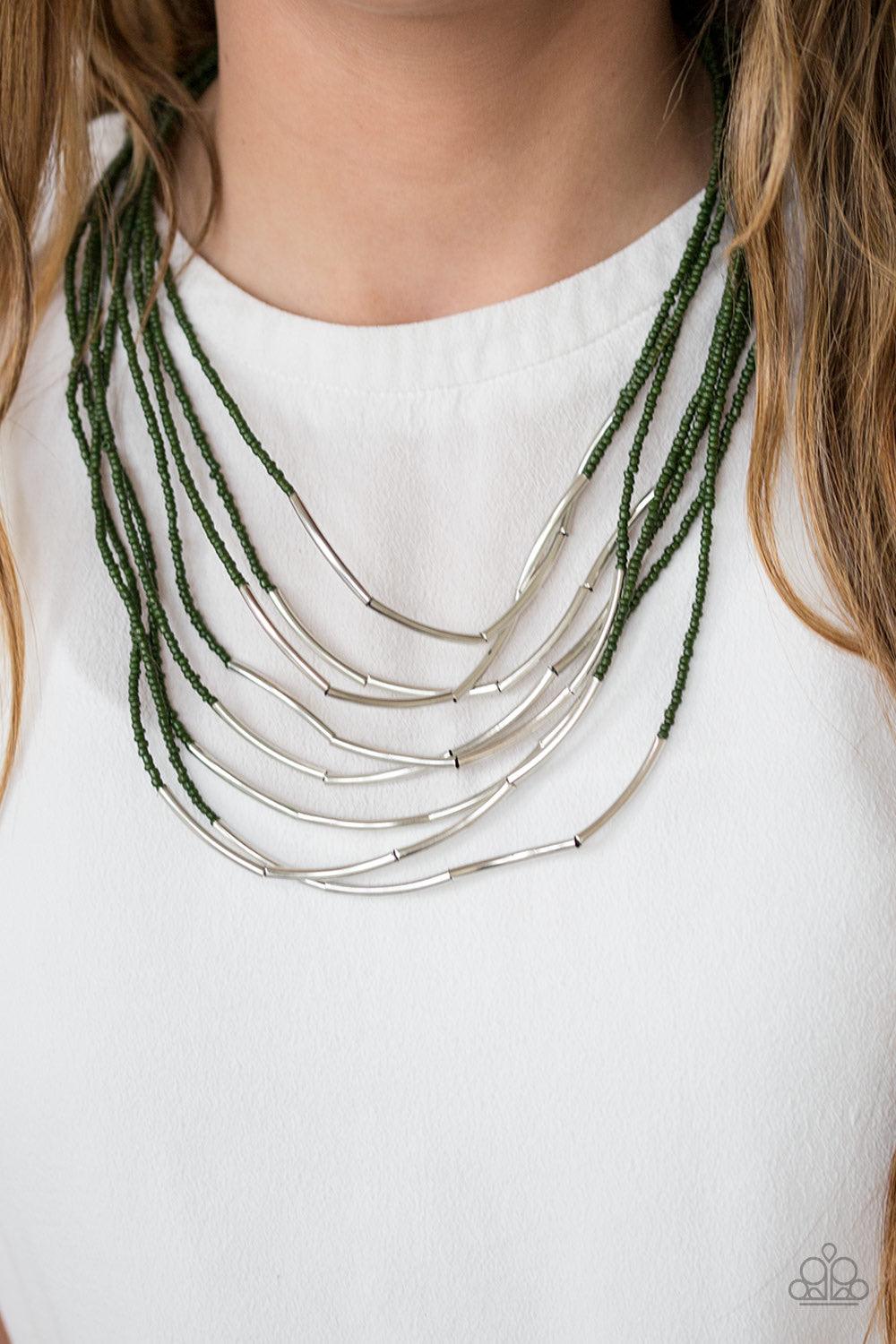 Paparazzi Accessories Living the GLEAM - Green Infused with two large silver fittings, shiny green seed beads are threaded along countless strands, creating dramatic layers below the collar. Shimmery silver accents slide along the centers of the strands,