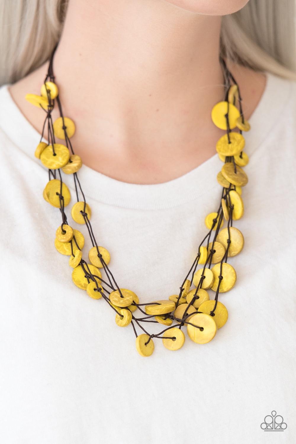 Paparazzi Accessories Bermuda Beach House - Yellow Tinted in a yellow finish, distressed wooden discs trickle along strands of knotted brown cording, creating colorful layers below the collar for a seasonal vibe. Features a button-loop closure. Jewelry