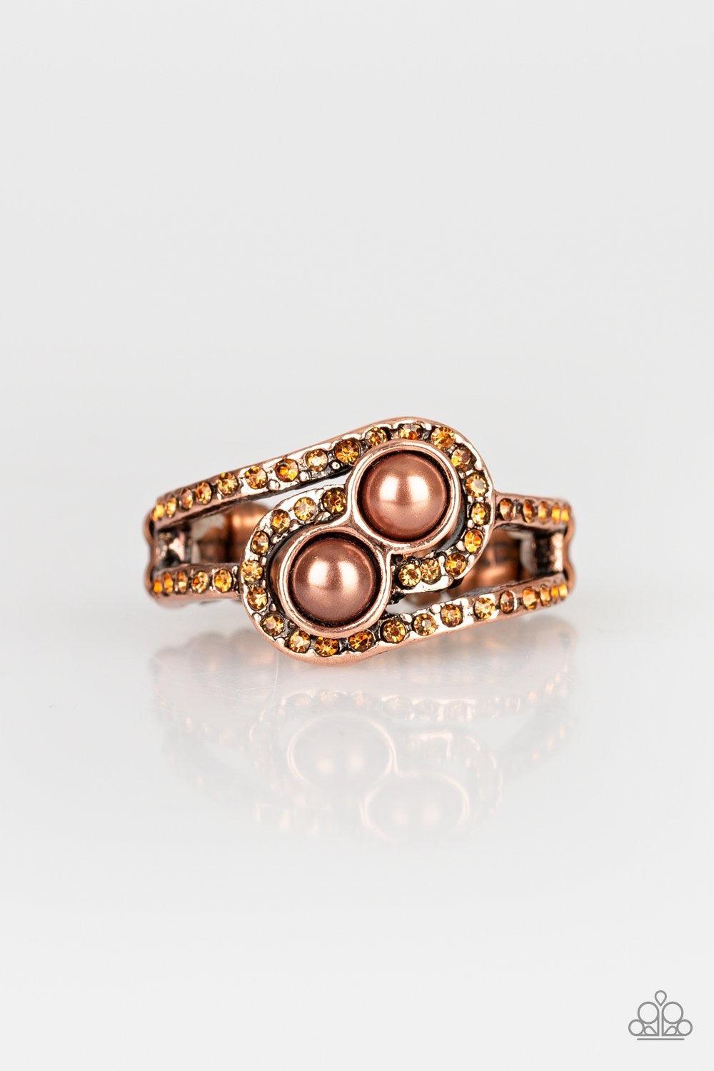 Paparazzi Accessories Collect Up Front - Copper Glittery topaz rhinestone encrusted bands swirl around a pair of coppery pearls for a refined look. Features a dainty stretchy band for a flexible f Jewelry