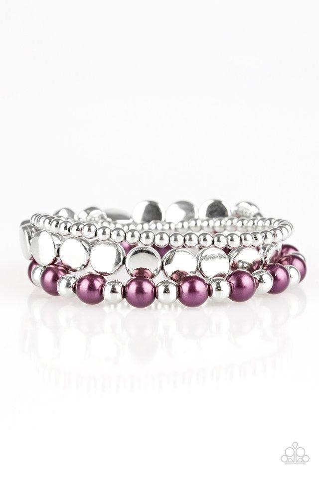 Paparazzi Accessories Girly Girl Glamour - Purple Mismatched silver and pearly purple beads are threaded along stretchy elastic bands, creating colorful layers across the wrist. Jewelry