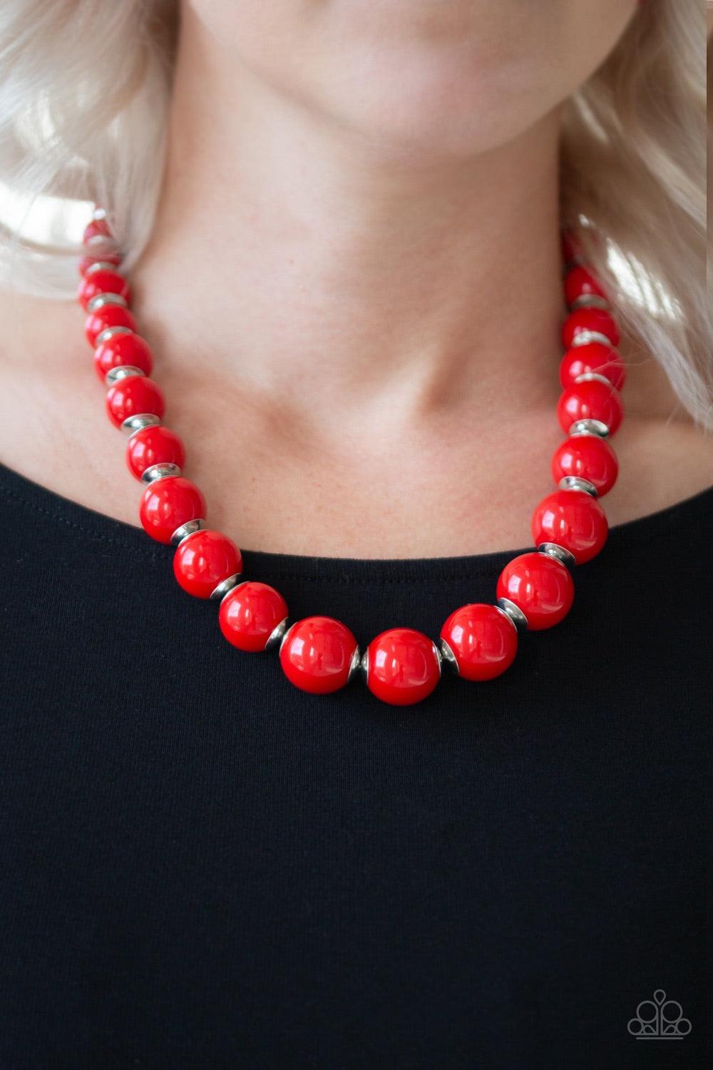 Paparazzi Accessories Everyday Eye Candy - Red Infused with metallic accents, fiery red beads gradually increase in size as they are threaded along an invisible wire below the collar for a vibrant pop of color. Features an adjustable clasp closure. Jewelr