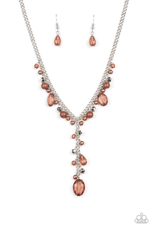 Paparazzi Accessories Crystal Couture - Brown Mismatched polished brown beads, crystal-like beads, and faceted silver beads dance along a shimmery silver chain. Matching beading trickles along a single silver chain, creating a romantic extended pendant be