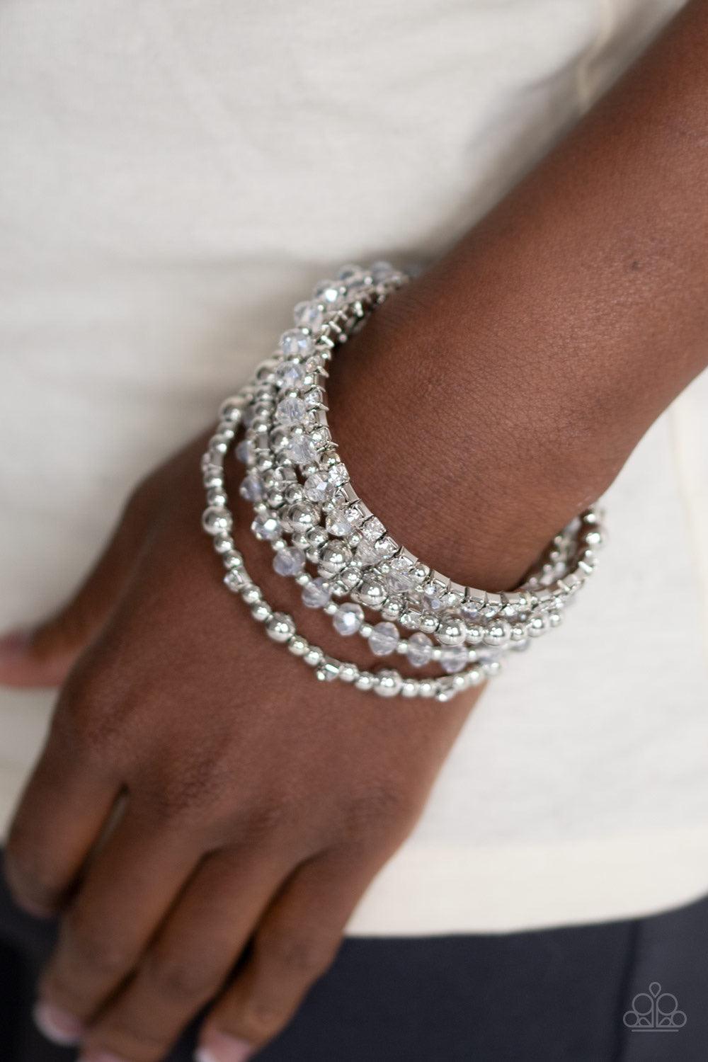 Paparazzi Accessories ICE Knowing You - White An icy collection of silver beads, silver cubes, white crystals, and glassy white rhinestones are threaded along a coiled wire, creating a blinding infinity wrap style bracelet around the wrist. Jewelry