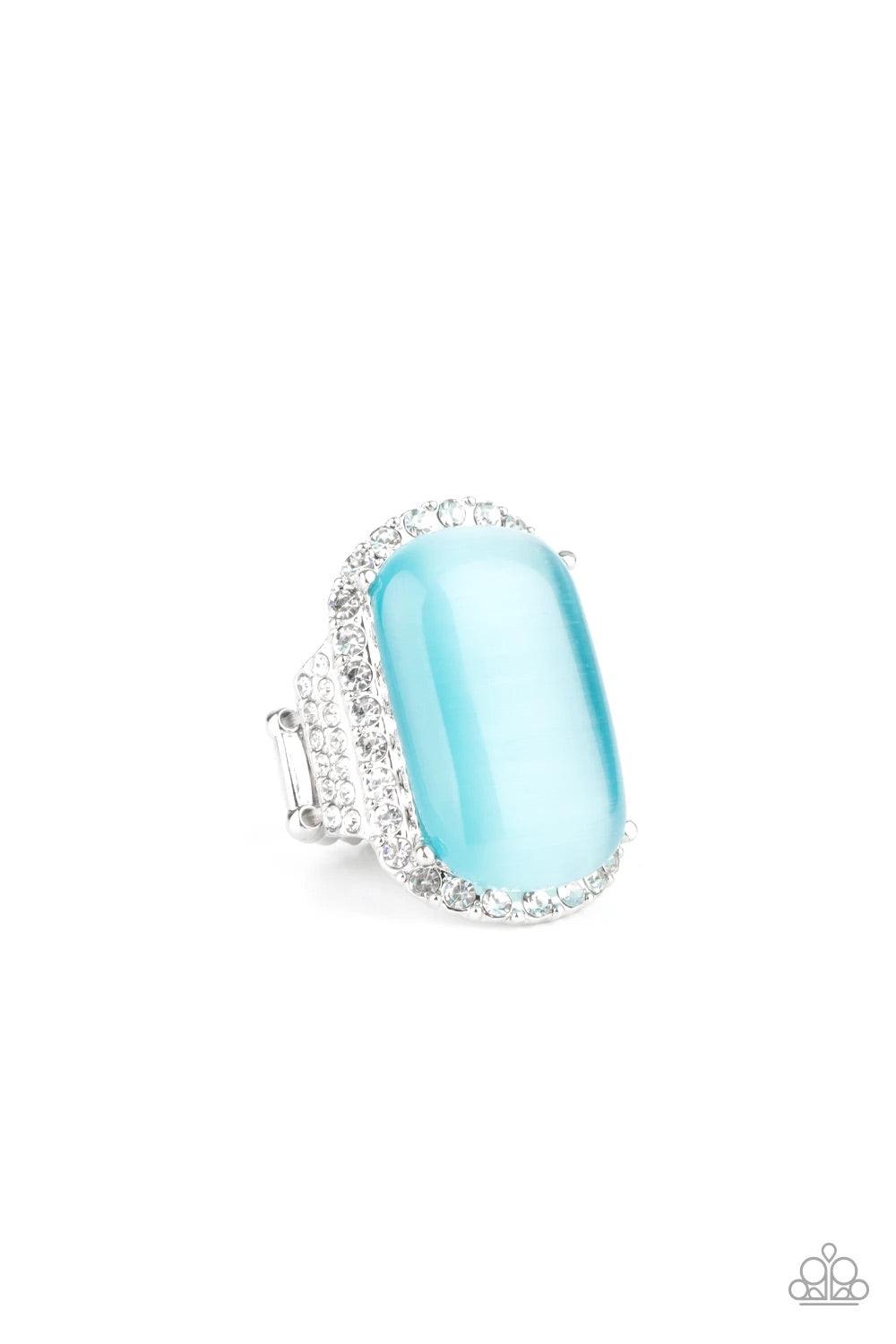 Paparazzi Accessories Thank Your LUXE-y Stars - Blue An oversized blue cat's eye stone sits atop an icy silver frame bedazzled in blinding white rhinestones for a luxurious look. Features a stretchy band for a flexible fit. Sold as one individual ring. Ri