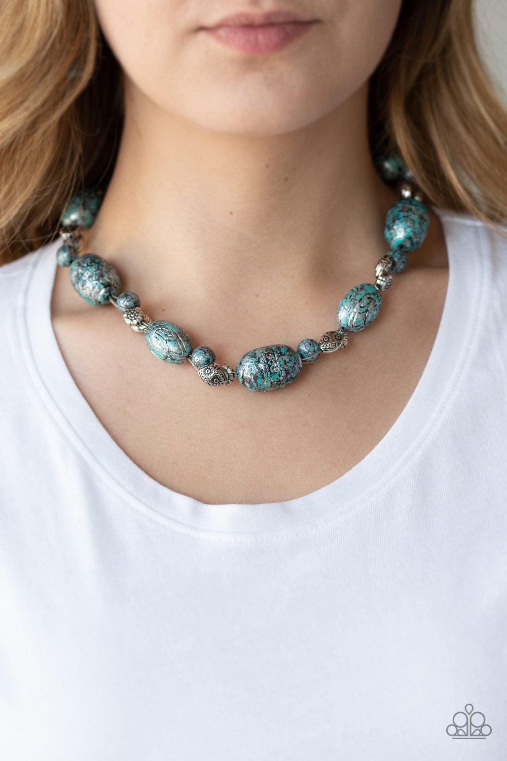 Paparazzi Accessories Gatherer Glamour - Blue Featuring a silvery patina finish, a collection of ornate beads and an array of floral stamped silver beads are threaded along invisible wire below the collar for a seasonal flair. Features an adjustable clasp