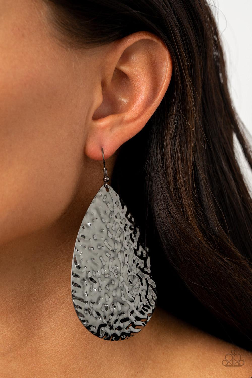 Paparazzi Accessories Metallic Mirrors - Black Hammered in a blinding finish, a rippling gunmetal teardrop swings from the ear for a bold industrial flair. Earring attaches to a standard fishhook fitting. Sold as one pair of earrings. Jewelry